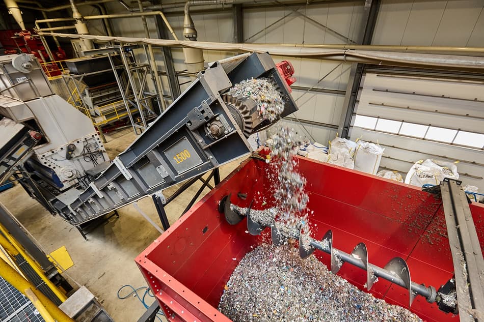 Plastic flakes being conveyed into a hopper