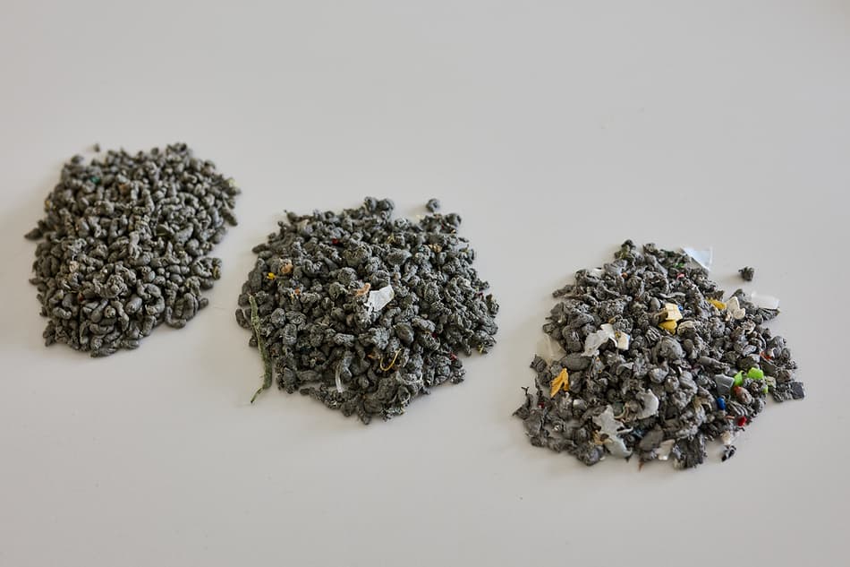Three samples of plastic granulate with varying degrees of purity
