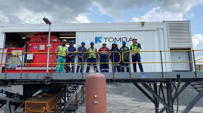 A group of people standing next to the TOMRA COM XRT 2.0 sorter