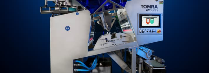 An image of the TOMRA 4C optical sorting machine on a dark background
