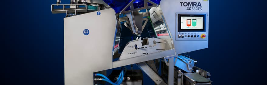 An image of the TOMRA 4C optical sorting machine on a dark background