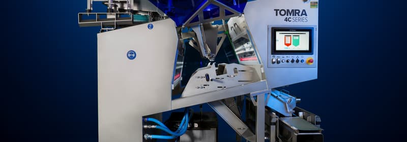 An image of the TOMRA 4C optical sorting machine on a dark background