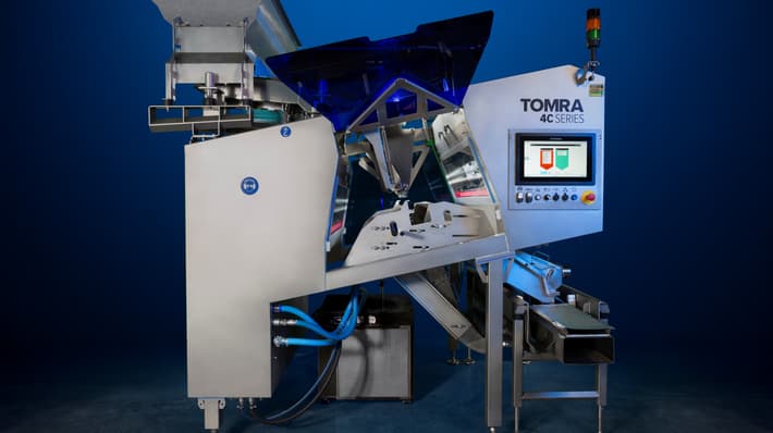 An image of the TOMRA 4C optical sorting machine on a dark background