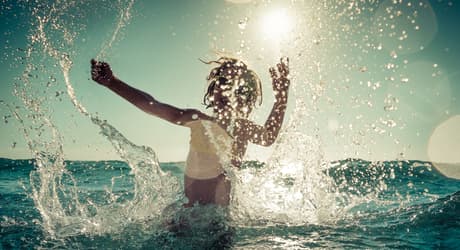 Child playing in ocean