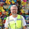 Alexander Verlo standing in front of plastic waste