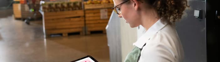 Woman looking at an iPad with TOMRA BinoQ Assist