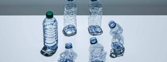 A circle of plastic bottles at various stages of being crushed