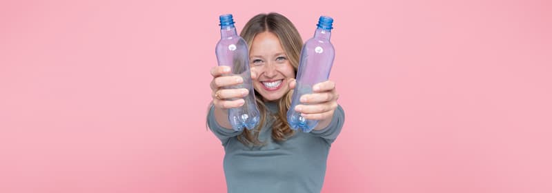 Smille woman with recyclable bottles 