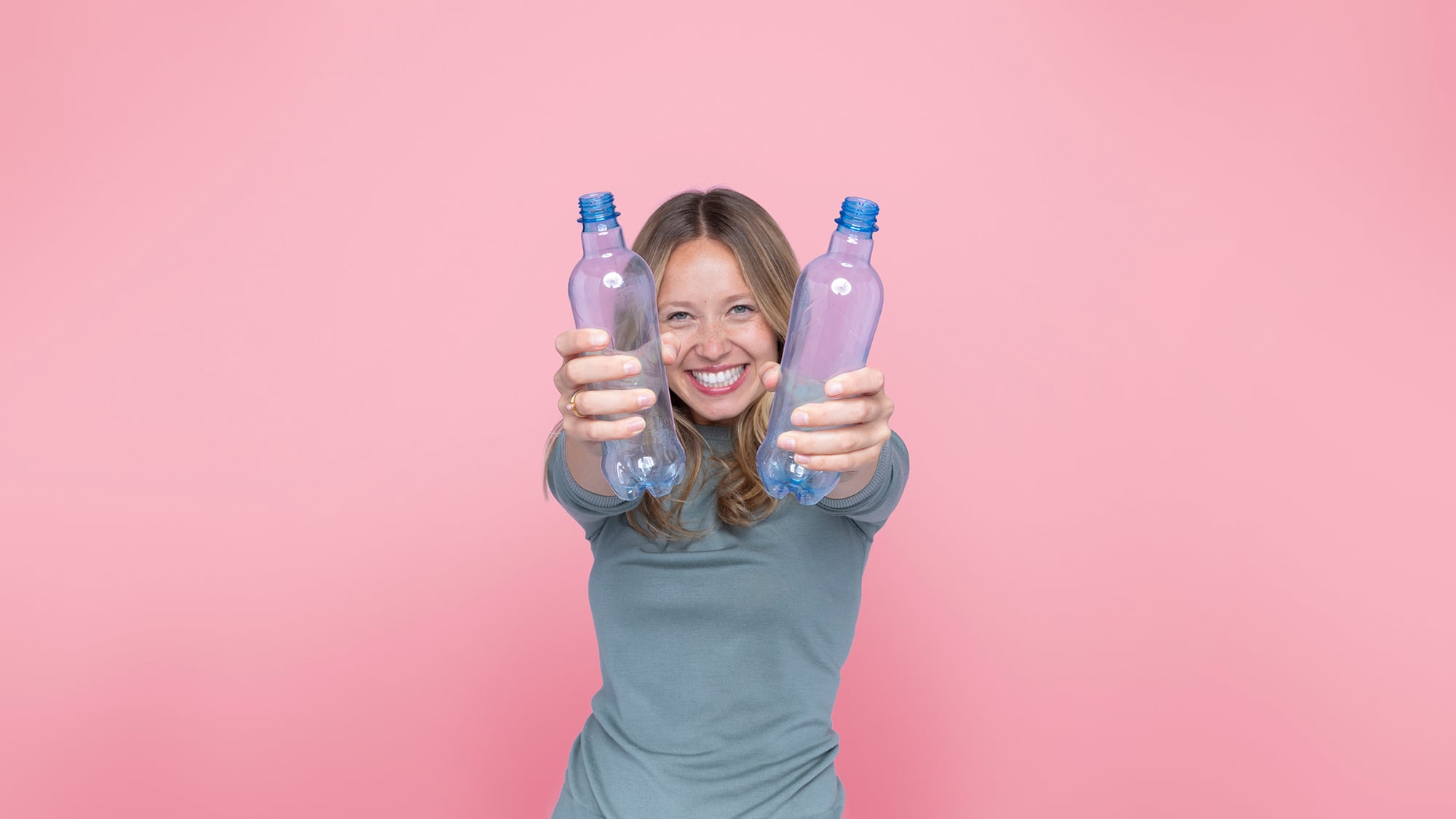 Smille woman with recyclable bottles 