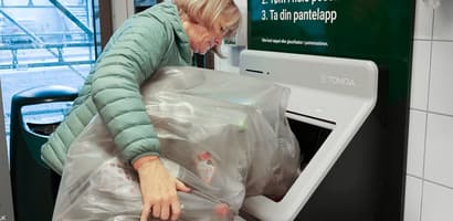 Customer in store using Tomra R2 reverse vending machine