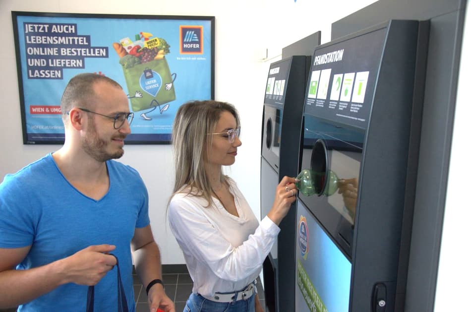 Man and Woman recycling bottles