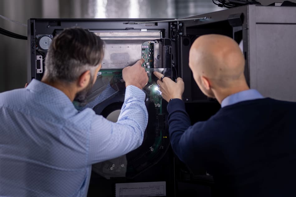 2 employees working with machine