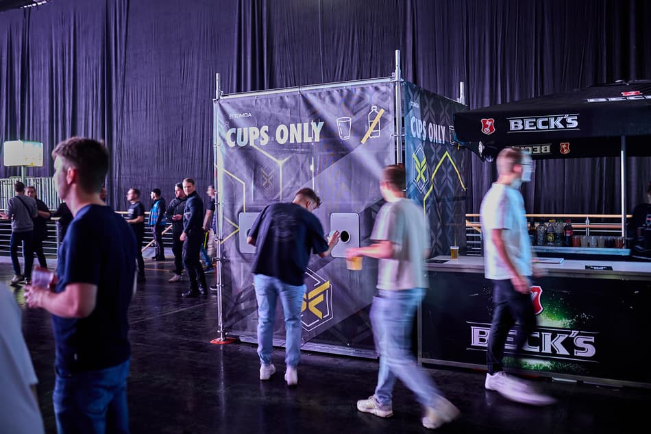 People at indoor festival returning reusable cups