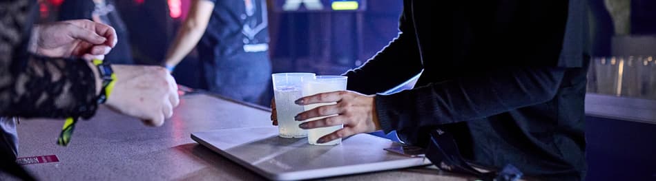 Event customer buying drinks in reusable cups