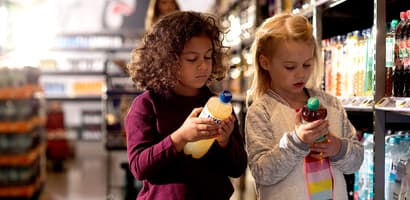 Girls looking at bottles in store