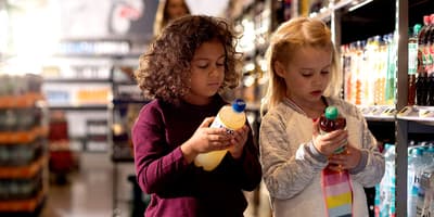 Girls looking at bottles in store