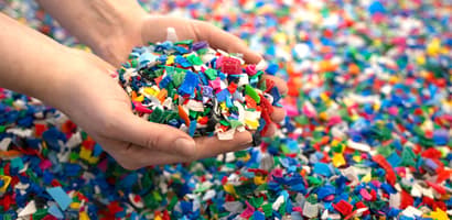 Hands holding colerful plastic pieces