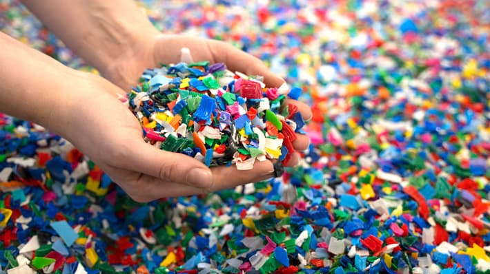 Hands holding colerful plastic pieces
