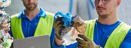 TOMRA Feedstock employees inspecting plastic feedstock material
