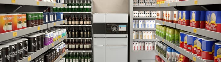 TOMRA reverse vending machine at the end of a supermarket aisle