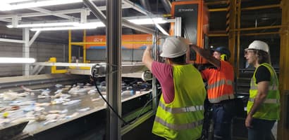 Men working on TOMRA AI Waste sorting machine