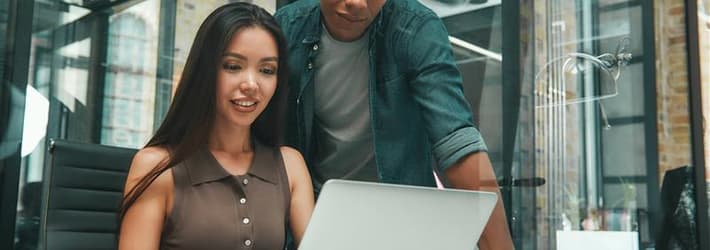 Woman and man looking at computer