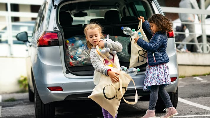 Kids getting containers from car boot