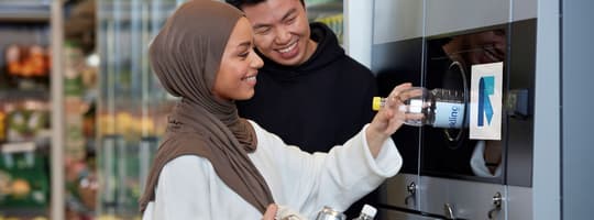Image of consumers returning containers to reverse vending machine