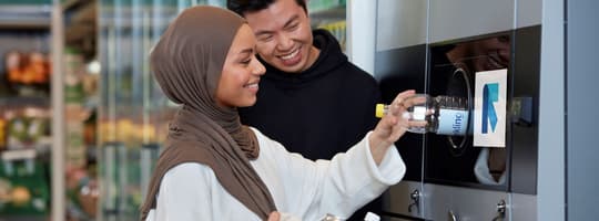 Image of consumers returning containers to reverse vending machine