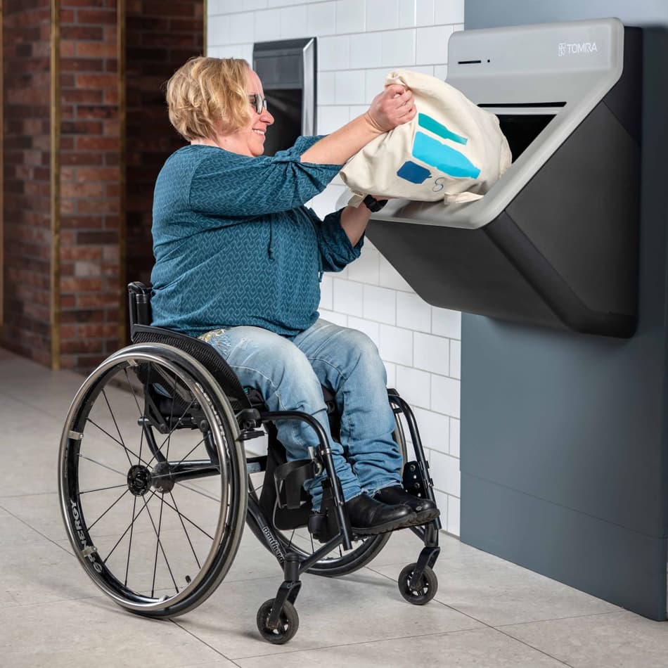 Image of user returning containers to reverse vending machine