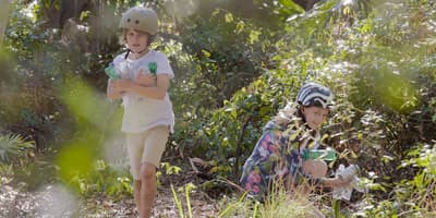 Kids picking up littered bottles