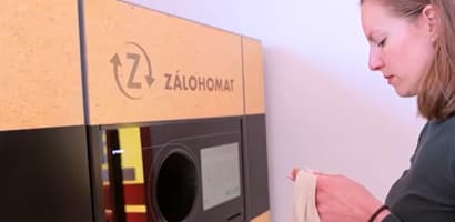 Woman returning bottles at TOMRA reverse vending machine in Slovakia