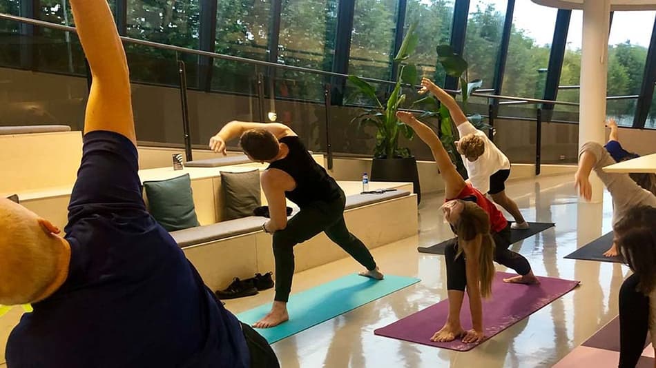 TOMRA employees doing yoga at the office
