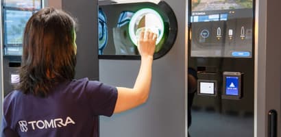 TOMRA employee with Singapore reverse vending machine