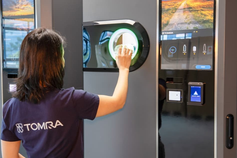 TOMRA employee with Singapore reverse vending machine
