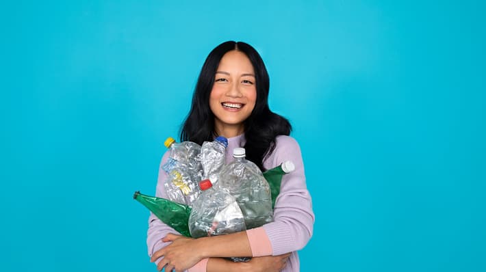 Woman holding used beverage containers