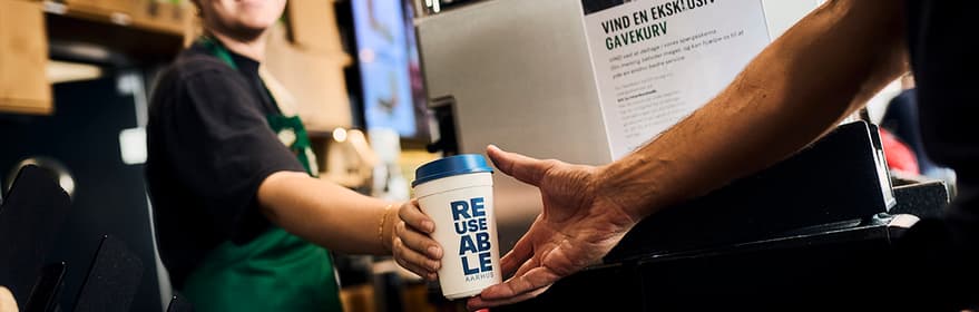 REUSEABLE coffee cup being purchased