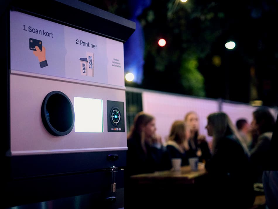 Night scene with REUSEABLE return machine and people sitting nearby