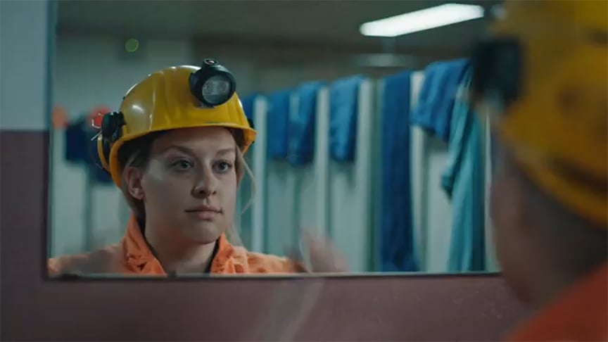 Woman with yellow construction helmet