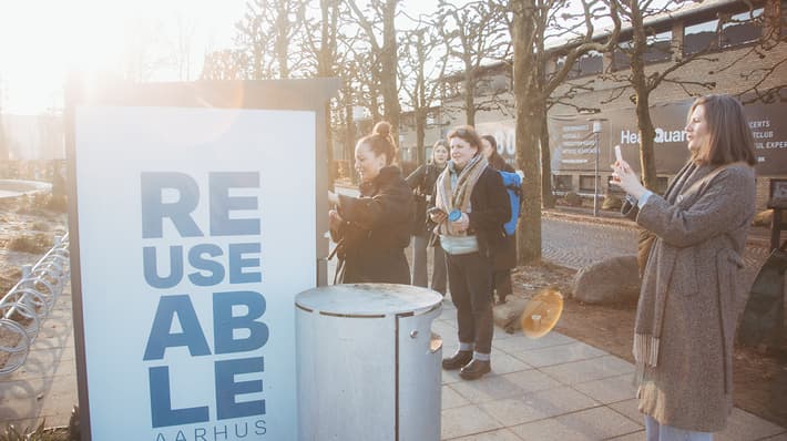 People using and taking photos of REUSEABLE collection point in Aarhus