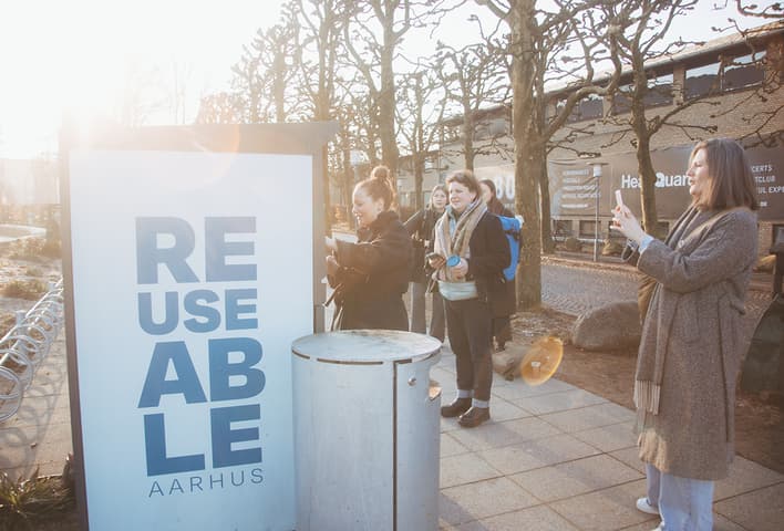 People using and taking photos of REUSEABLE collection point in Aarhus