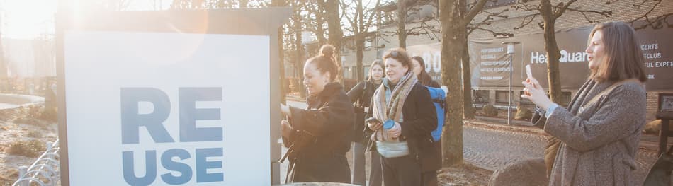 Group of people using and taking photos of REUSEABLE machine in Aarhus