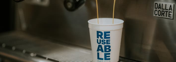 coffee being brewed into a reusable cup