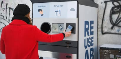 Consumer returning a reusable cup at a TOMRA collection point in Aarhus Denmark