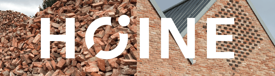 used bricks on left side of banner combined with a building on right side with HØINE imposed on top 