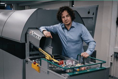 imagen de un hombre junto a una máquina de clasificación