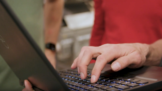 image: Person typing on laptop
