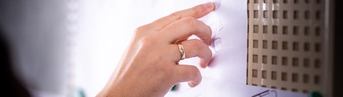 A hand traces the drawn lines of a product design