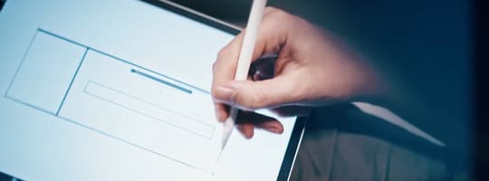 A pen draws the drawn lines of a product design on a tablet device