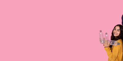 two women in a pink background holding empties